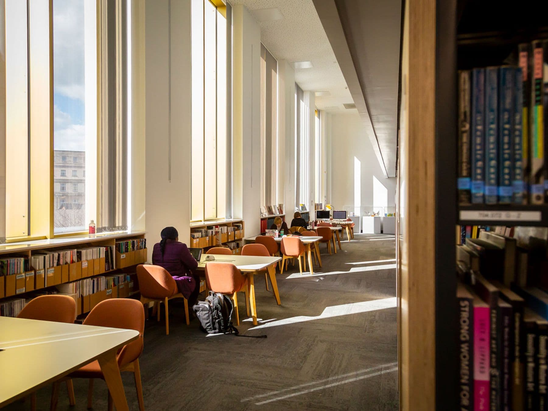 Photograph of students reading at tables in our peaceful library setting.