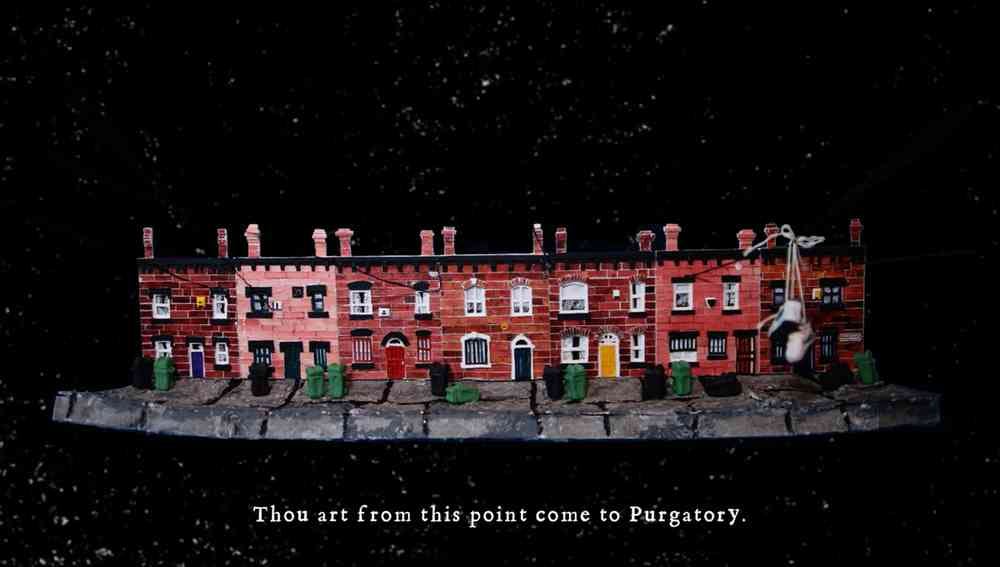 A model of seven terraced brick houses on a grey pavement, each with a different coloured door. The background is black and the text underneath reads: Thou art from this point come to Purgatory.