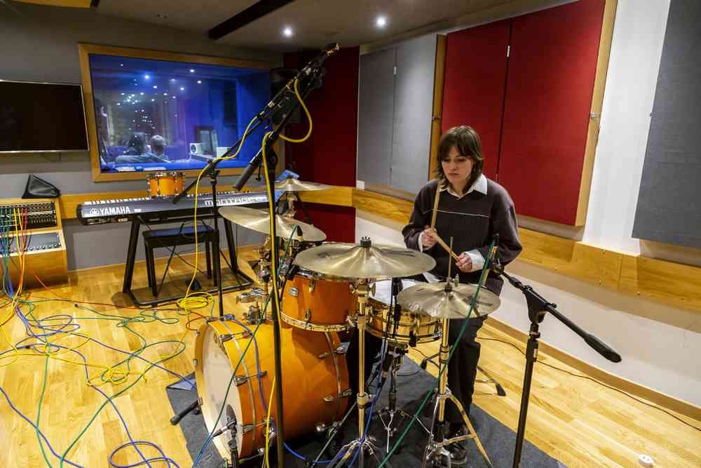 Student on the drums in the recording studio