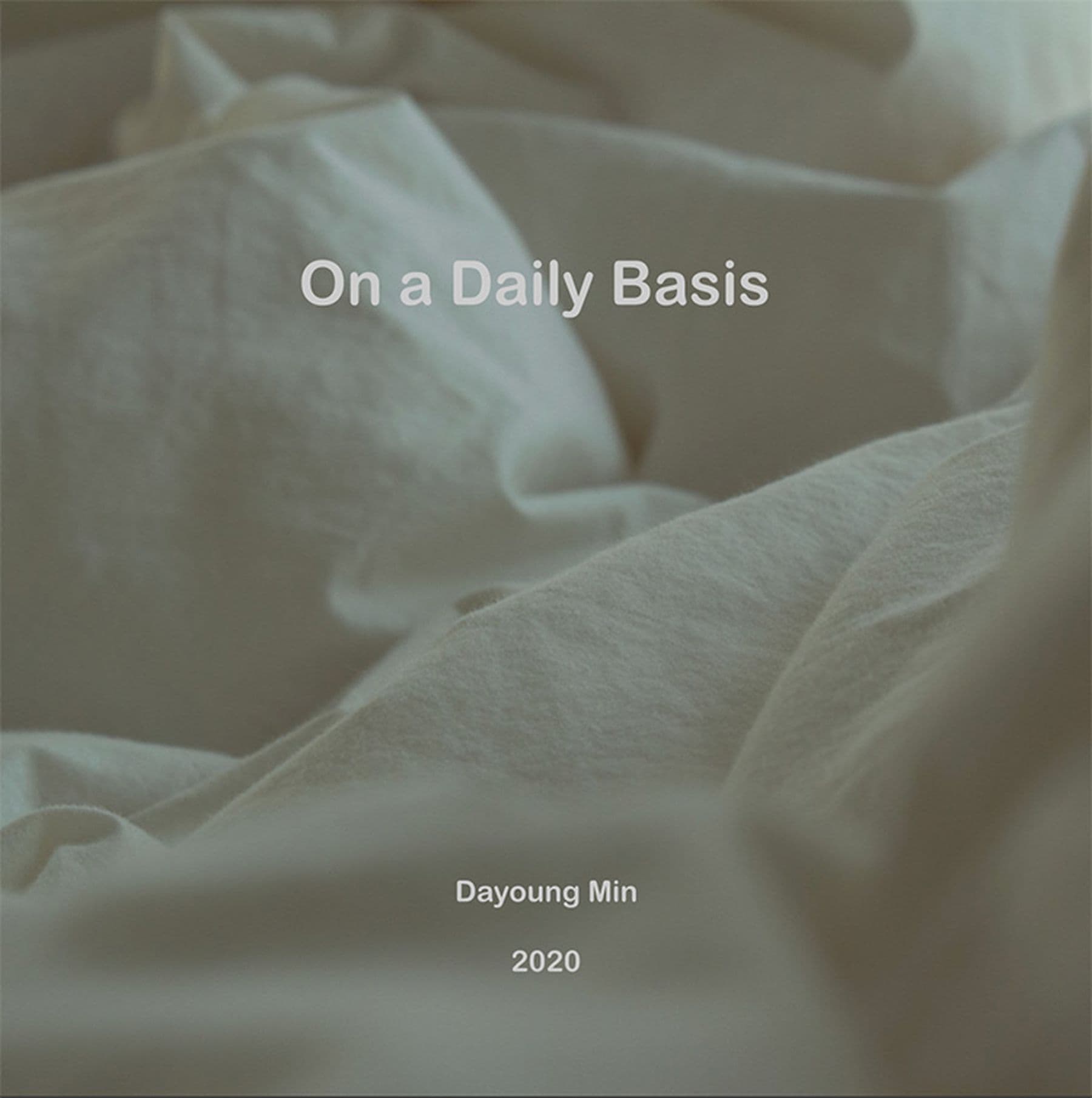 A photograph of a soft, crumpled white sheet with text that reads:  'On a Daily Basis' and 'Dayoung Min 2020' overlaid.